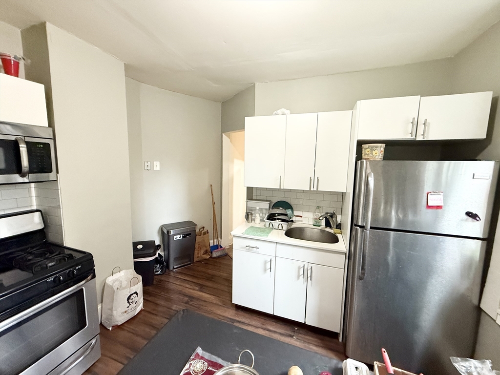 8 Wave Avenue, Unit 1 Boston, MA 02125 - Photo 2 of 10 a kitchen with a refrigerator and a stove
