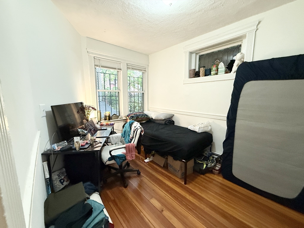 8 Wave Avenue, Unit 1 Boston, MA 02125 - Photo 6 of 10 a living room with furniture and a mirror