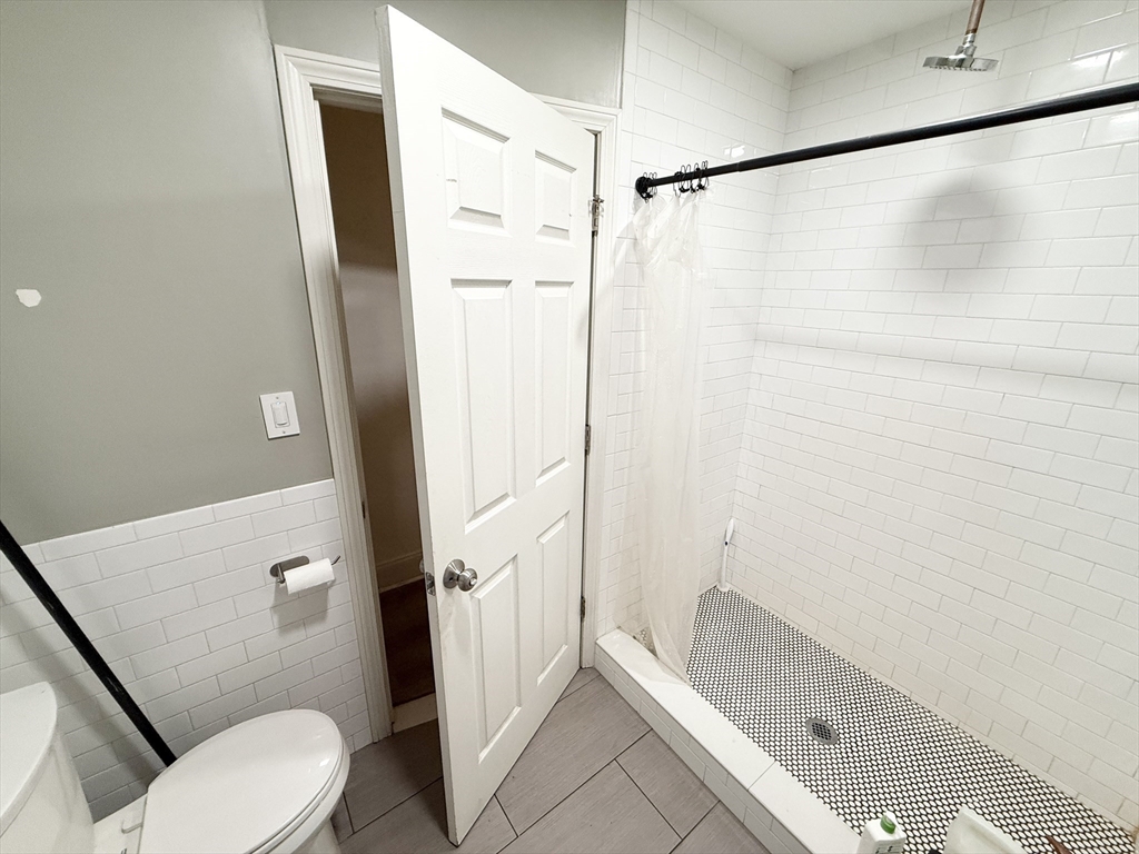 8 Wave Avenue, Unit 1 Boston, MA 02125 - Photo 9 of 10 a bathroom with a shower and a toilet