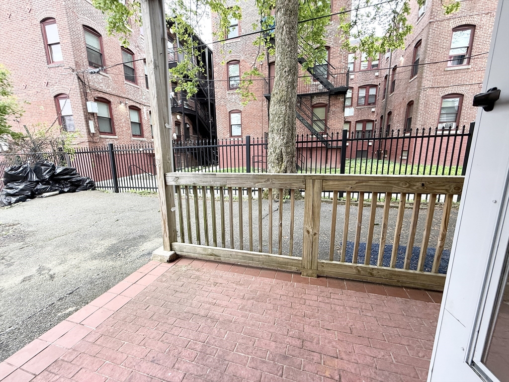 8 Wave Avenue, Unit 1 Boston, MA 02125 - Photo 10 of 10 a view of a brick house with wooden fence