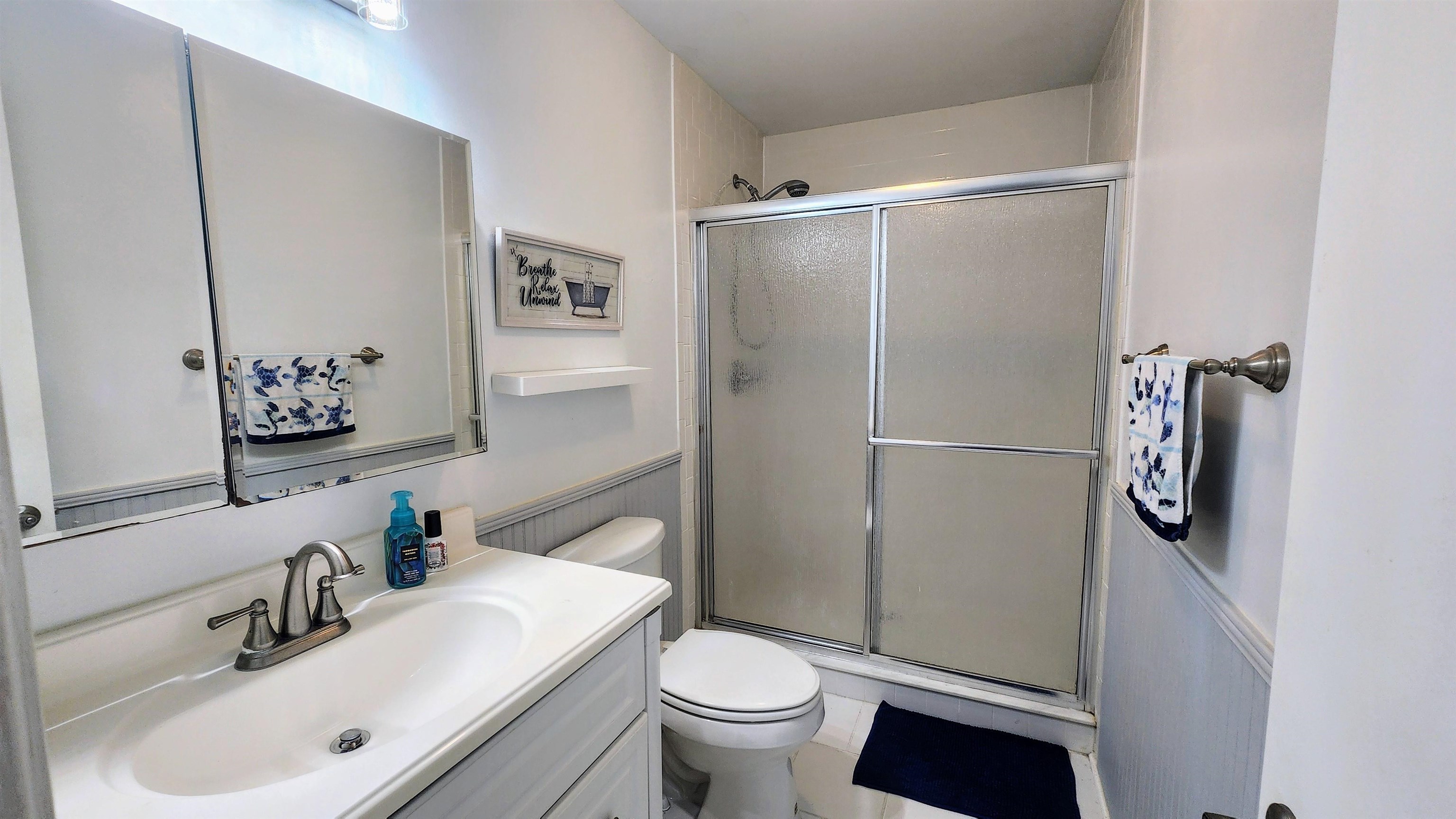 616 Bowers Lane St. Augustine, FL 32080 - Photo 11 of 18 a bathroom with a sink toilet and shower