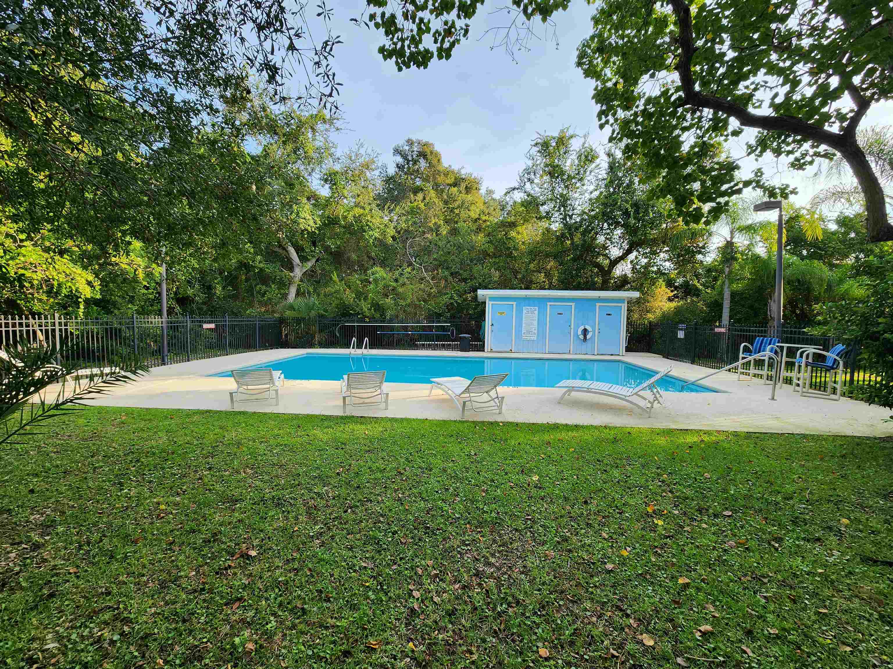 616 Bowers Lane St. Augustine, FL 32080 - Photo 17 of 18 a view of a swimming pool and trees in the background