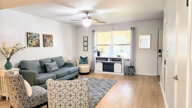 a living room with furniture and a fireplace