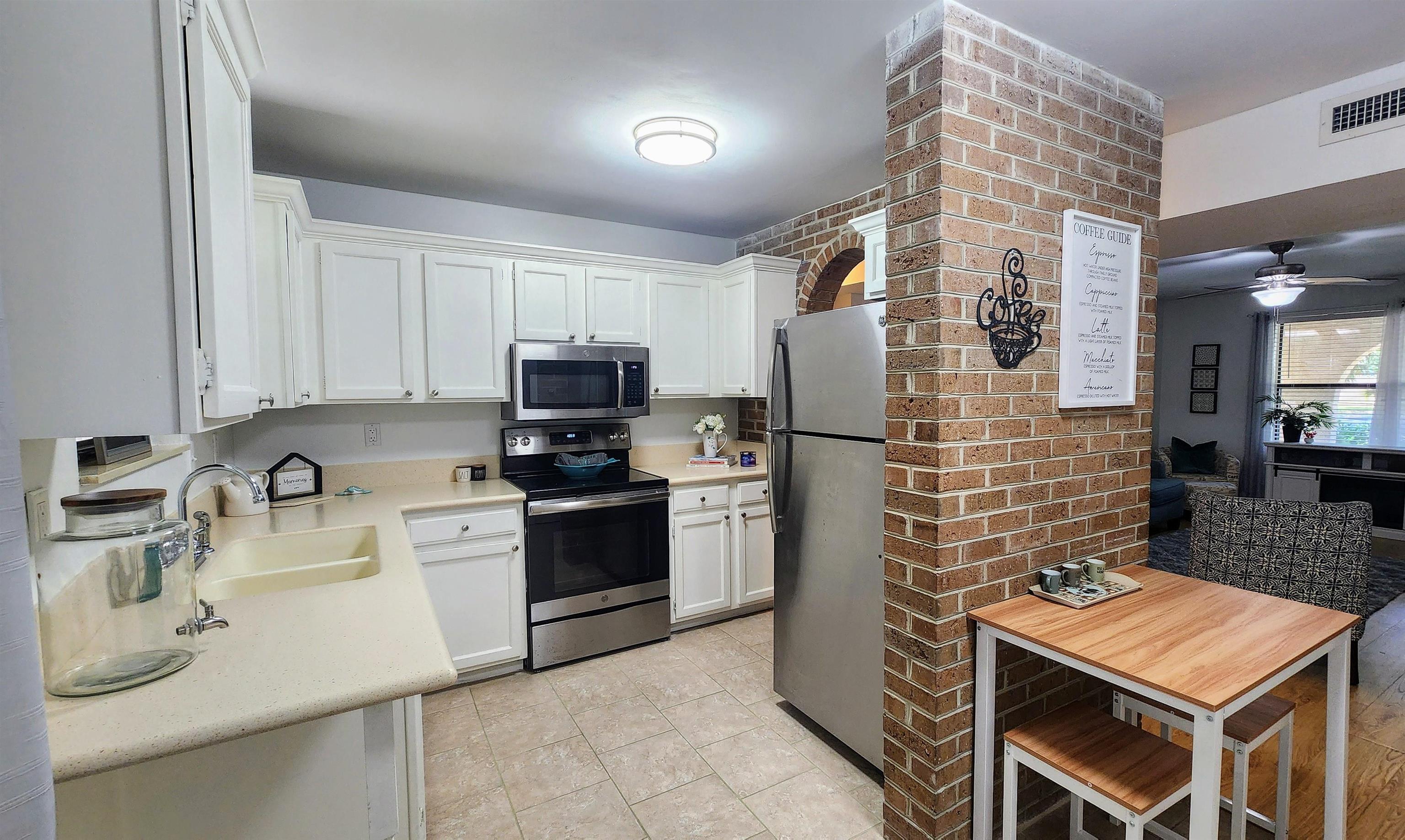 616 Bowers Lane St. Augustine, FL 32080 - Photo 5 of 18 a kitchen with stainless steel appliances granite countertop a sink stove and refrigerator