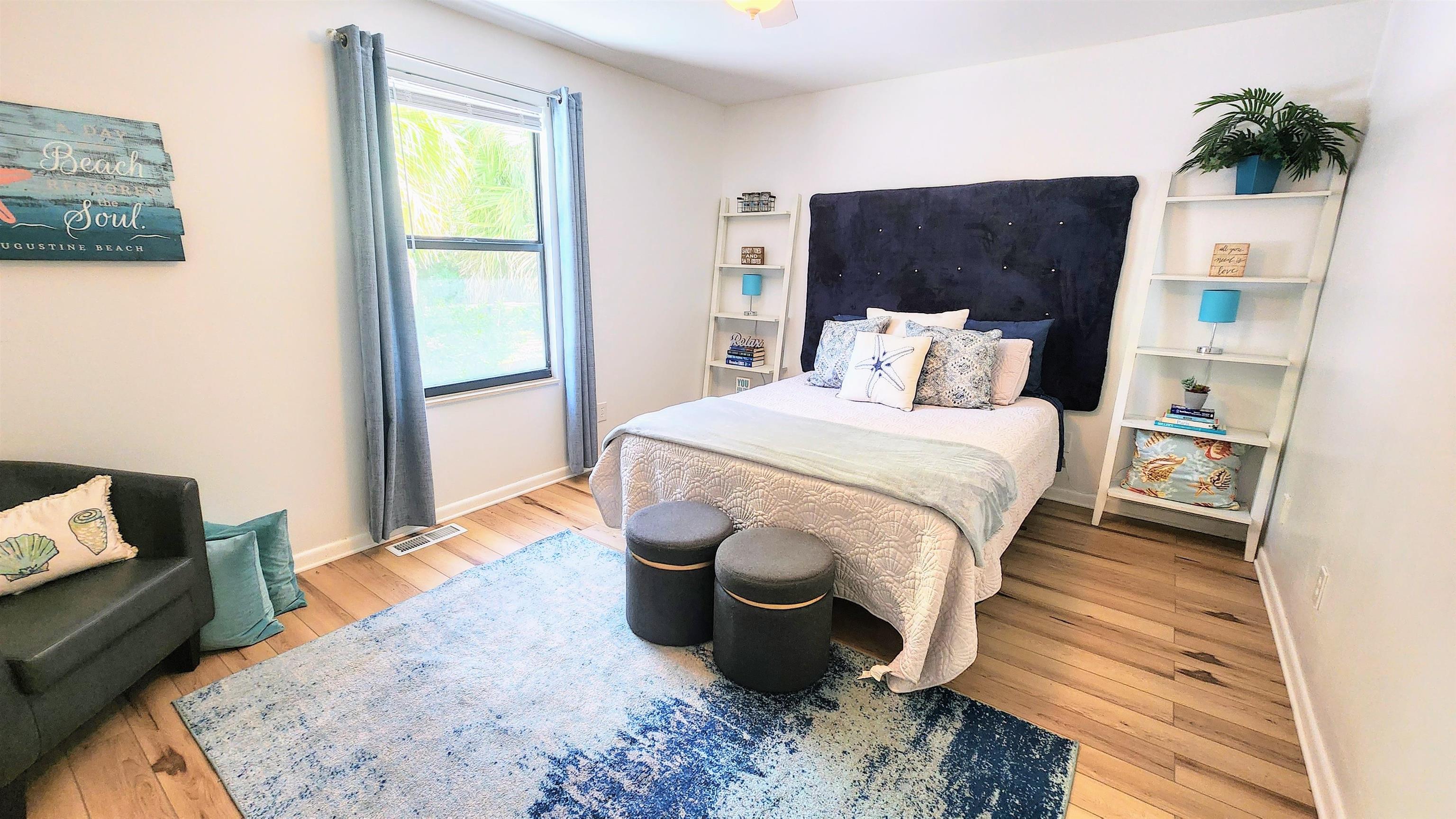 616 Bowers Lane St. Augustine, FL 32080 - Photo 9 of 18 a bedroom with a bed and wooden floor