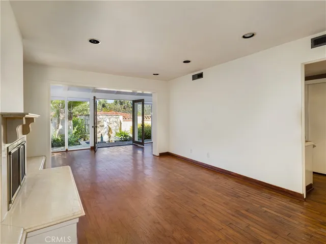 a view of a livingroom with wooden floor and a window
