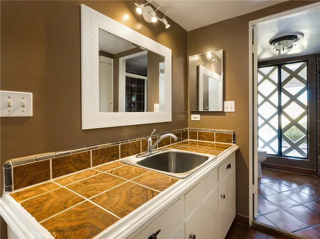 a room with pool table and windows