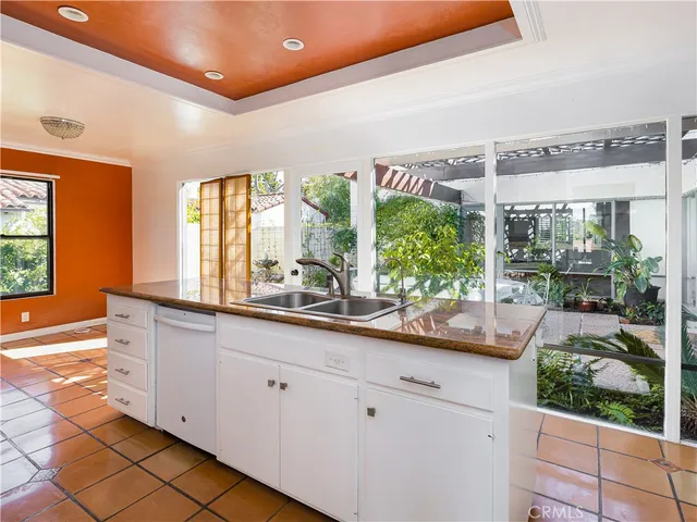 a kitchen with sink and large window