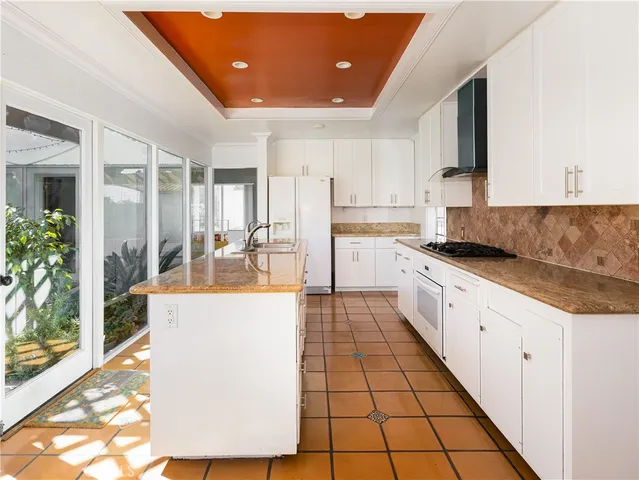 a kitchen with stainless steel appliances granite countertop a sink and cabinets