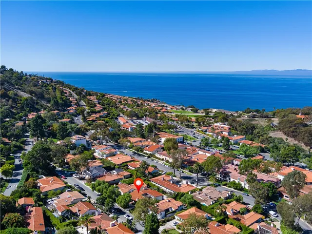 an aerial view of a house with a yard swimming pool and outdoor seating