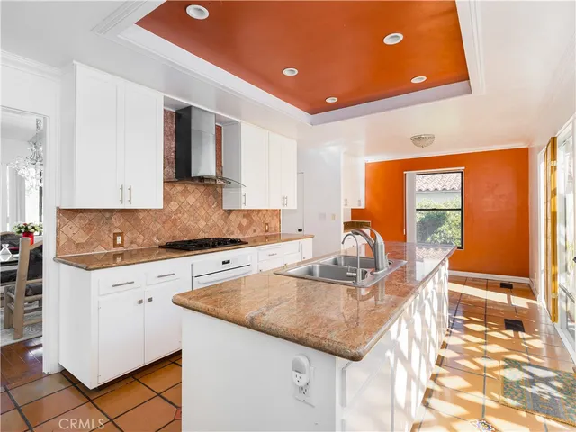 a kitchen with granite countertop a sink and cabinets
