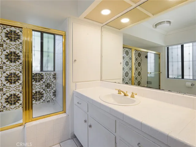 a bathroom with a sink double vanity and a shower