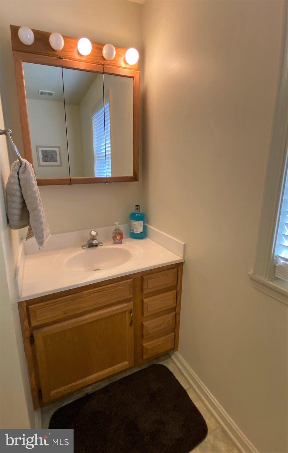540 Platte Road Lusby, MD 20657 - Photo 10 of 16 a bathroom with a sink and a mirror