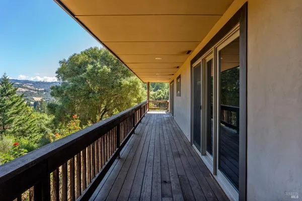 a view of balcony with wooden floor