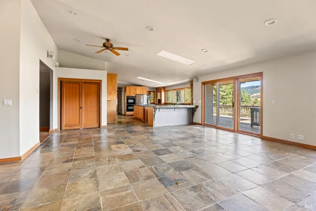 a view of empty room with a kitchen