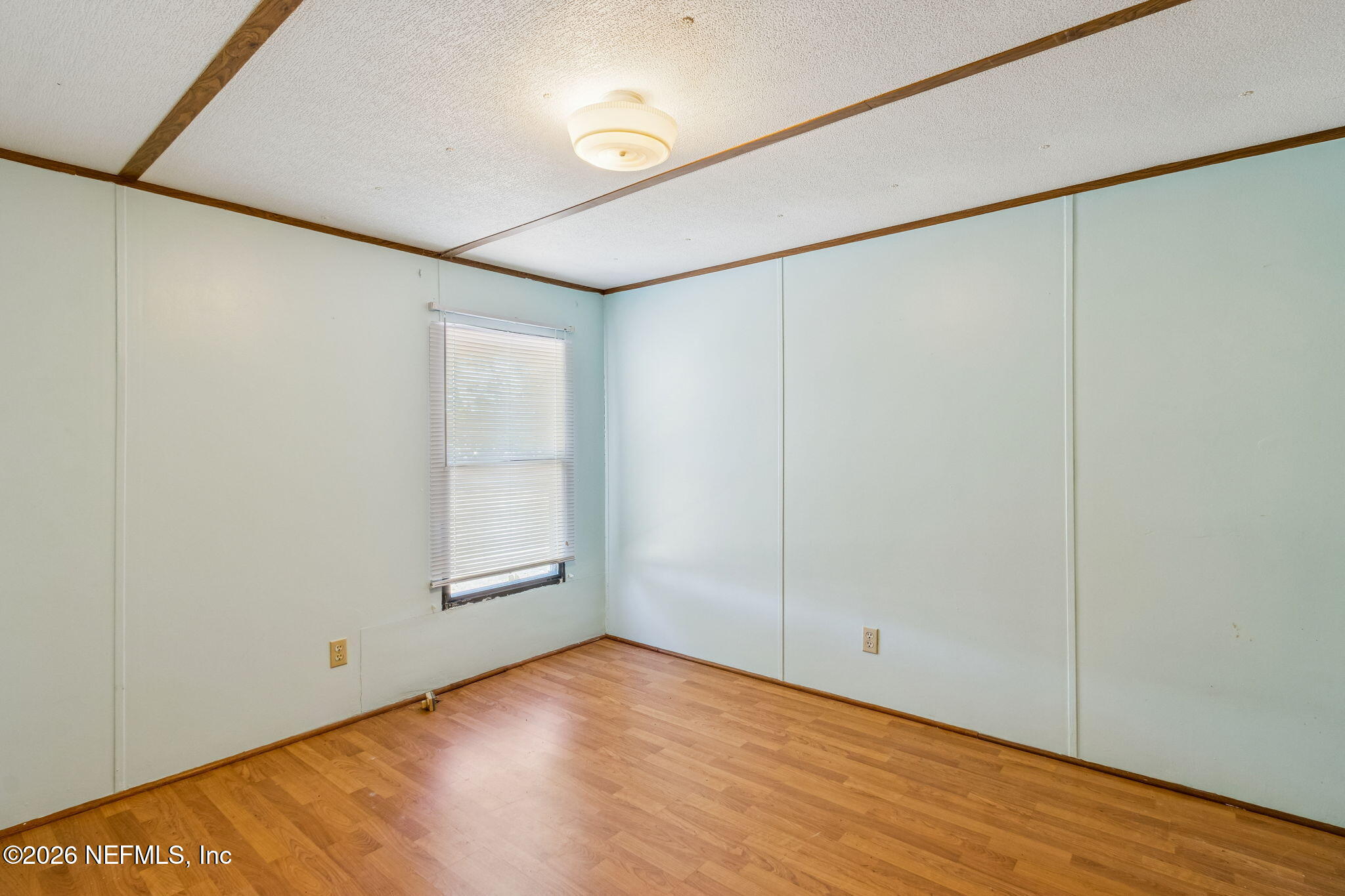86341 Goodbread Road Yulee, FL 32097 - Photo 11 of 27 a view of an empty room with wooden floor and a window