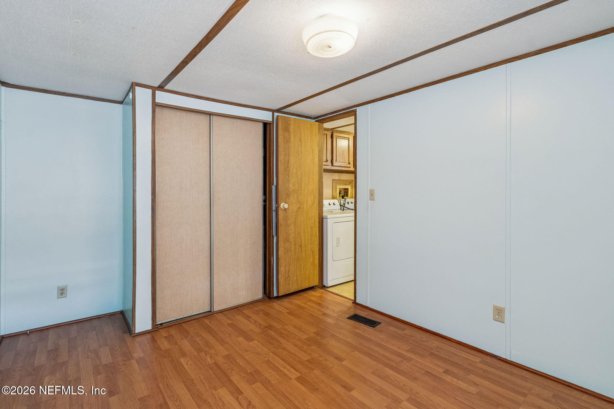 86341 Goodbread Road Yulee, FL 32097 - Photo 12 of 27 a view of an empty room with wooden floor