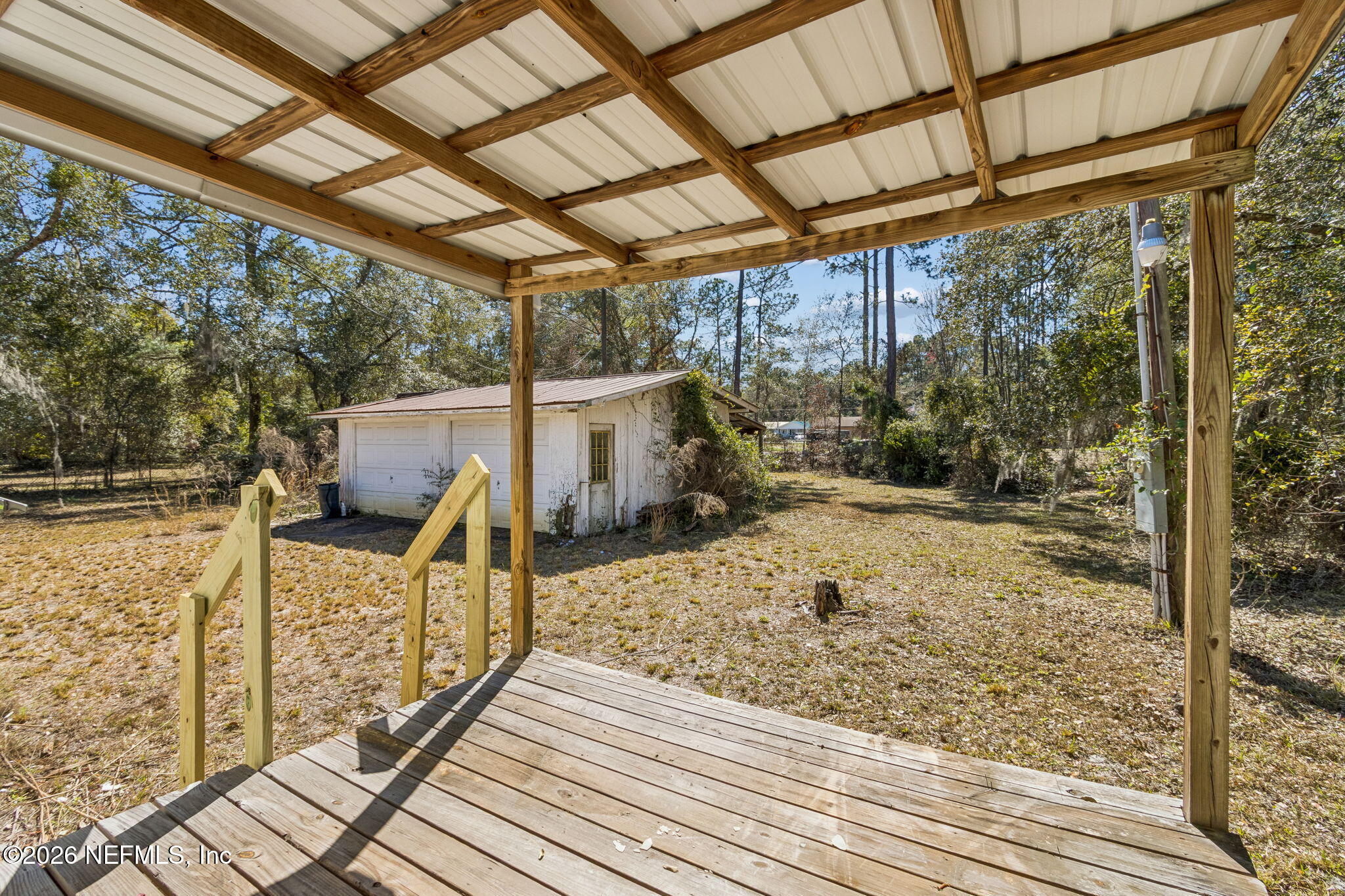86341 Goodbread Road Yulee, FL 32097 - Photo 19 of 27 a view of a balcony with chairs and wooden floor