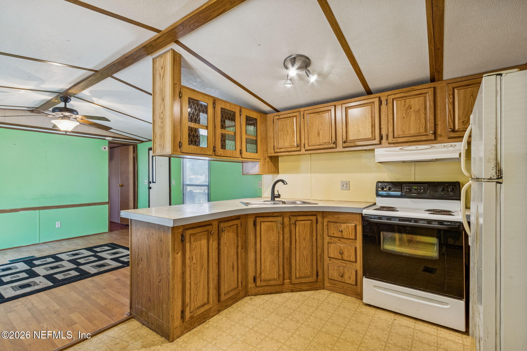86341 Goodbread Road Yulee, FL 32097 - Photo 9 of 27 a kitchen with cabinets a stove and a window