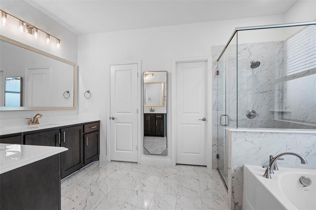 753 Truchas Avenue Forney, TX 75126 - Photo 14 of 29 a spacious bathroom with a shower sink and mirror