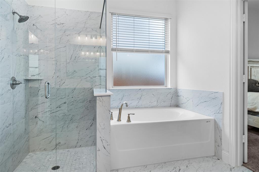 753 Truchas Avenue Forney, TX 75126 - Photo 16 of 29 a bathroom with a bathtub and shower