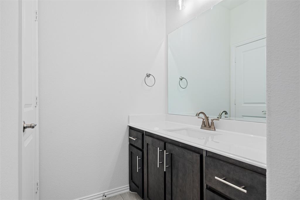 753 Truchas Avenue Forney, TX 75126 - Photo 25 of 29 a bathroom with a sink and a mirror