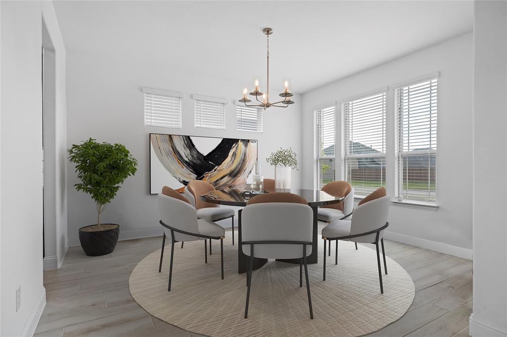 753 Truchas Avenue Forney, TX 75126 - Photo 4 of 29 a dining room with furniture a chandelier and wooden floor