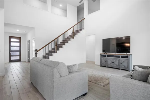 a living room with furniture and a flat screen tv