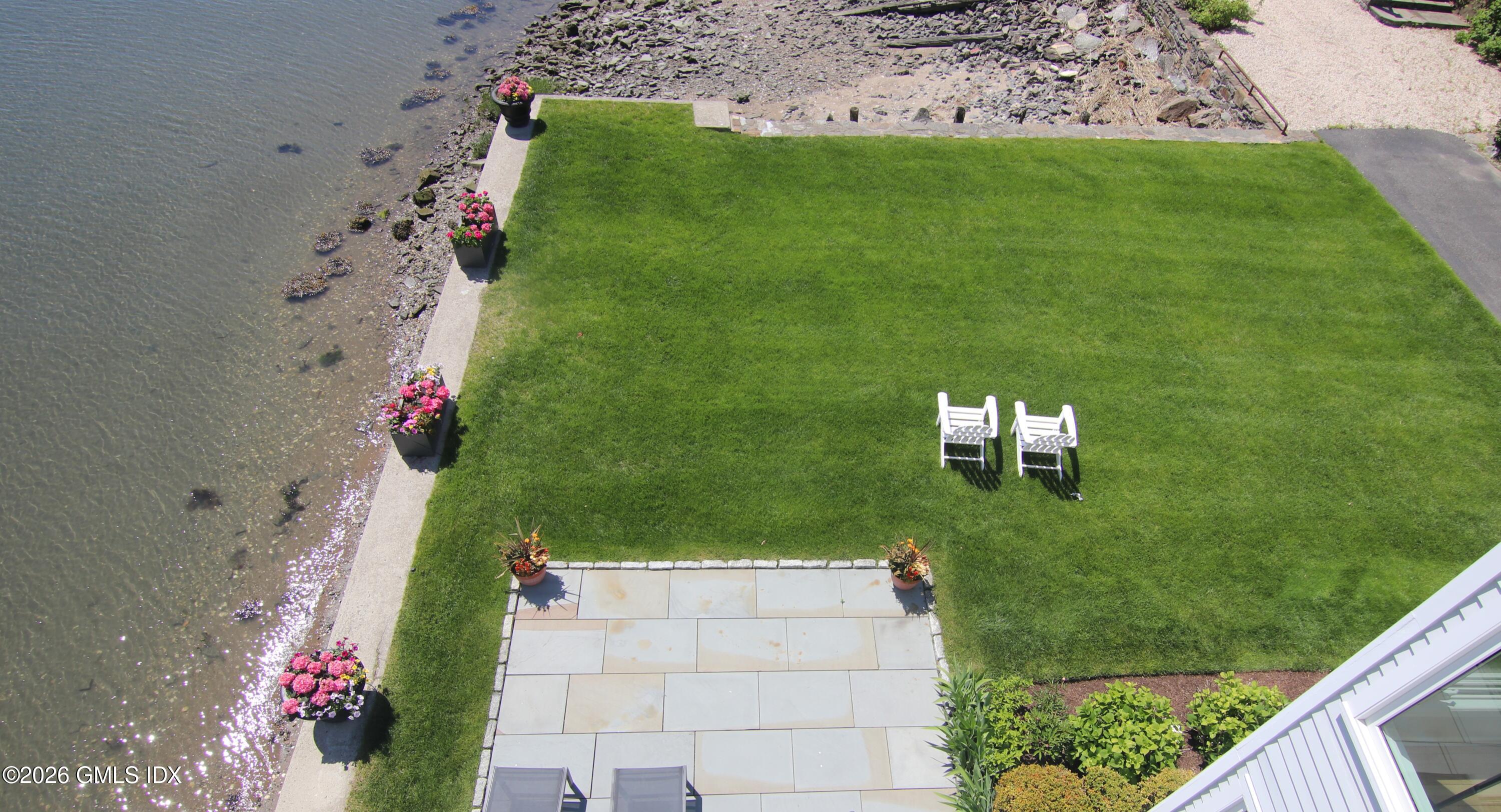 633 Steamboat Road, Unit 5 Greenwich, CT 06830 - Photo 2 of 29 a view of a big yard with potted plants
