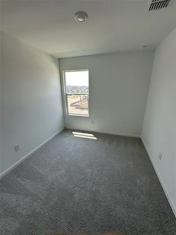 a view of an empty room and a window