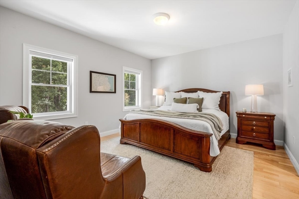 14 Longwood Lane, Unit 14 Hanover, MA 02339 - Photo 12 of 42 a bedroom with a bed and wooden floor