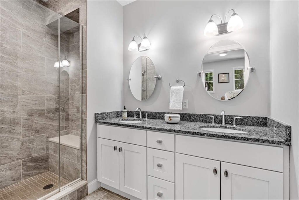 14 Longwood Lane, Unit 14 Hanover, MA 02339 - Photo 14 of 42 a bathroom with a granite countertop sink a mirror and shower