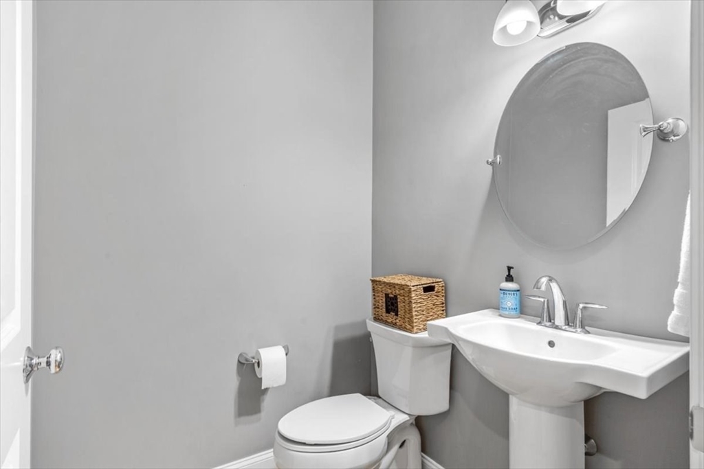 14 Longwood Lane, Unit 14 Hanover, MA 02339 - Photo 17 of 42 a white toilet sitting next to a bathroom sink
