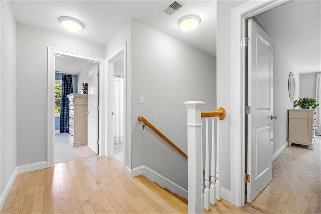 14 Longwood Lane, Unit 14 Hanover, MA 02339 - Photo 20 of 42 a view of a hallway with paintings on the wall