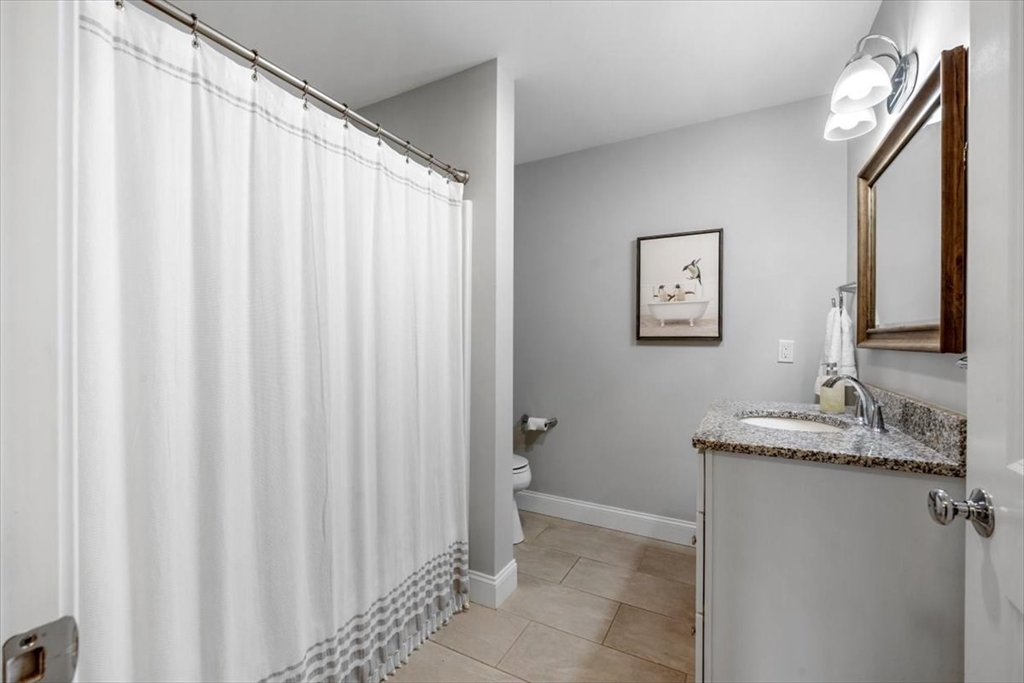 14 Longwood Lane, Unit 14 Hanover, MA 02339 - Photo 22 of 42 a bathroom with a granite countertop sink and a mirror