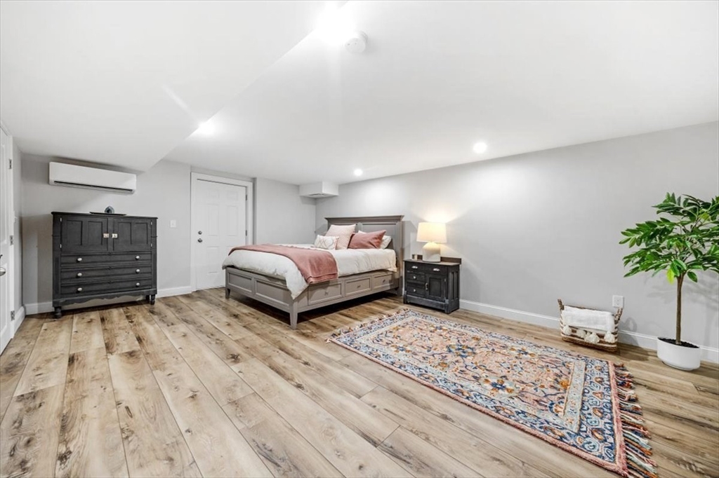 14 Longwood Lane, Unit 14 Hanover, MA 02339 - Photo 28 of 42 a spacious bedroom with a bed and a potted plant