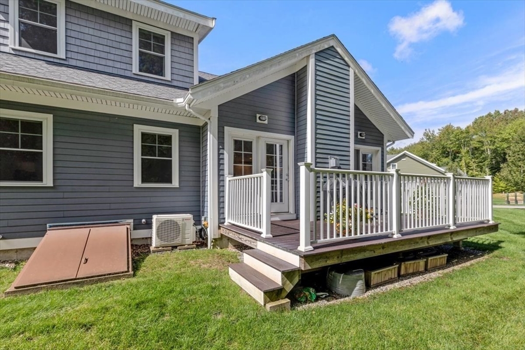 14 Longwood Lane, Unit 14 Hanover, MA 02339 - Photo 35 of 42 a view of a house with a small yard and wooden fence