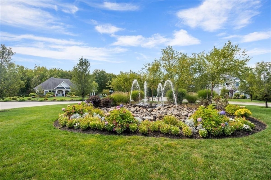14 Longwood Lane, Unit 14 Hanover, MA 02339 - Photo 38 of 42 a view of a garden with a building in the background