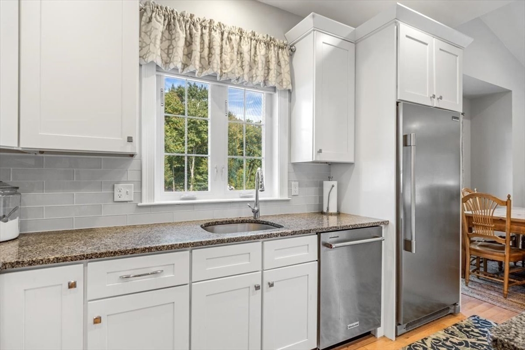 14 Longwood Lane, Unit 14 Hanover, MA 02339 - Photo 5 of 42 a kitchen with granite countertop a sink stainless steel appliances and cabinets