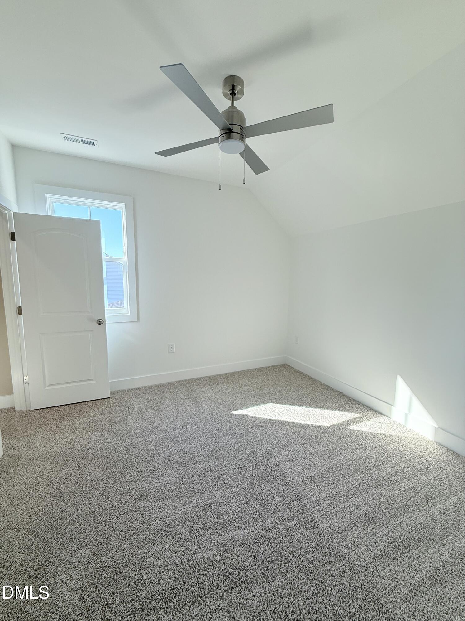 6906 Fire Tower Road Spring Hope, NC 27882 - Photo 21 of 32 an empty room with a ceiling fan and a window
