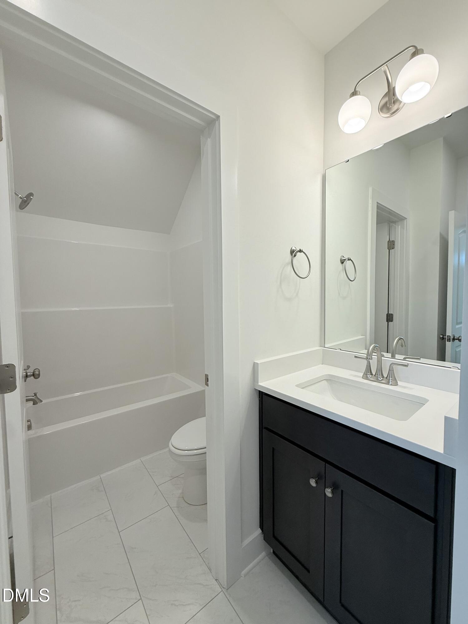 6906 Fire Tower Road Spring Hope, NC 27882 - Photo 24 of 32 a bathroom with a sink a toilet and shower