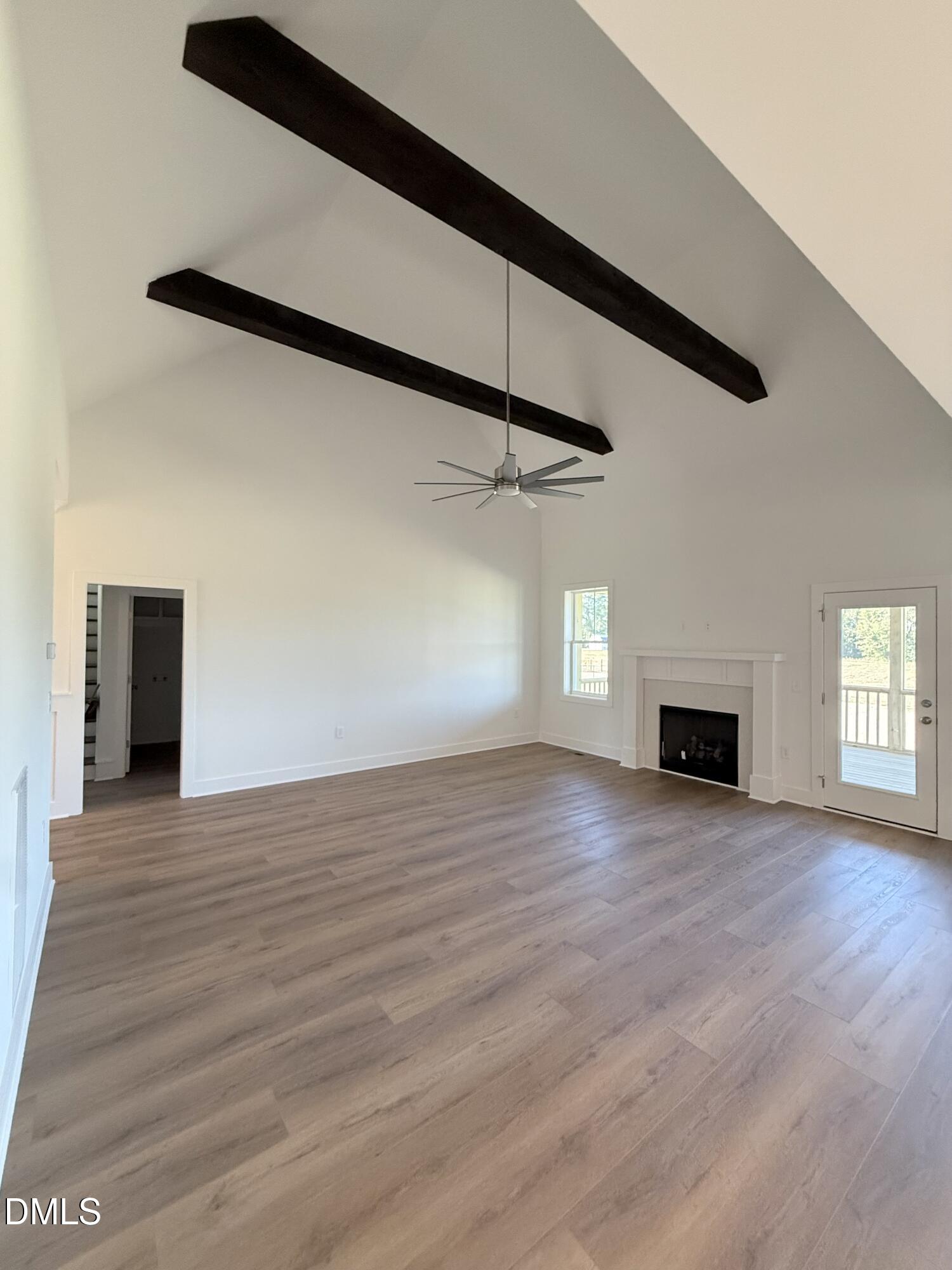 6906 Fire Tower Road Spring Hope, NC 27882 - Photo 9 of 32 a view of a livingroom with wooden floor and a fireplace