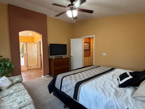 a bedroom with a bed and a flat screen tv