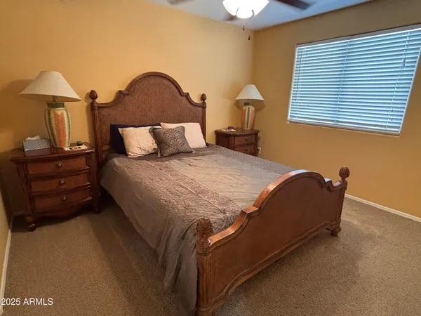 a bedroom with a bed and a lamp