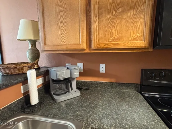 a kitchen with a sink and a stove next to a window