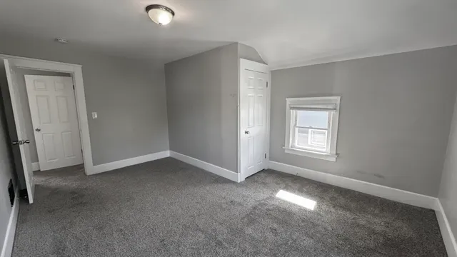 an empty room with closet area