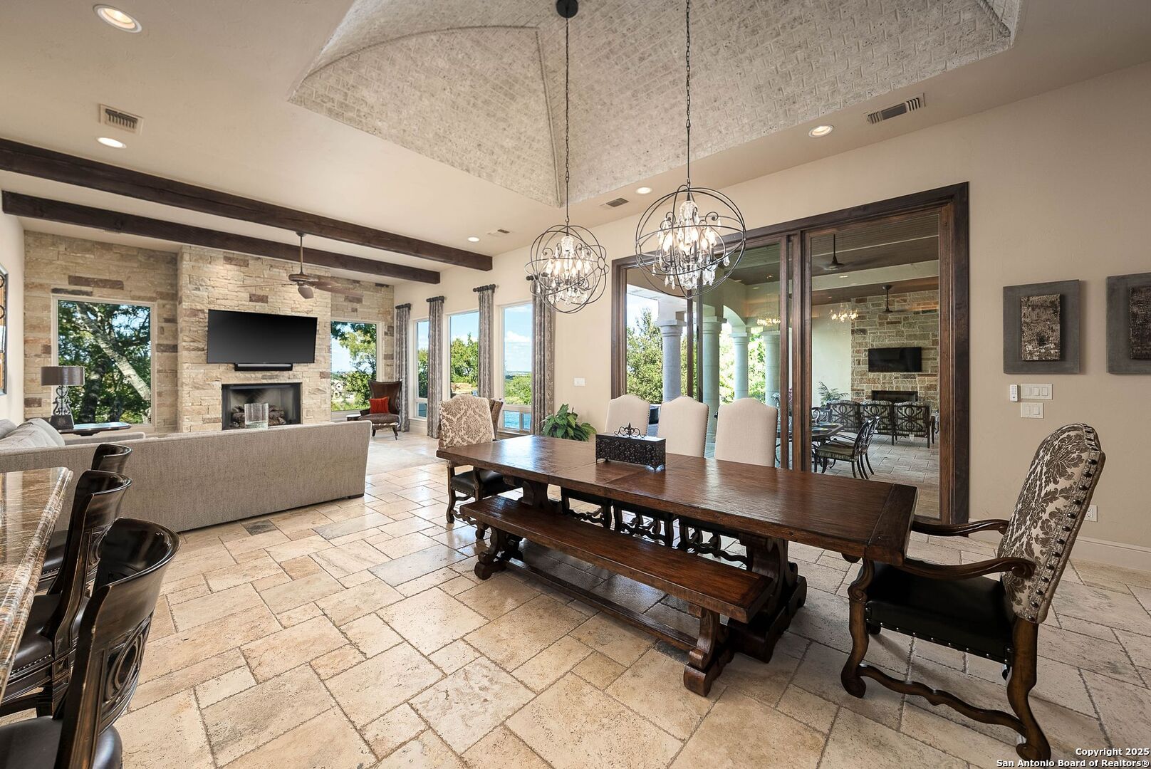 631 Menger Springs Boerne, TX 78006 - Photo 11 of 54 a living room with furniture a chandelier and a flat screen tv