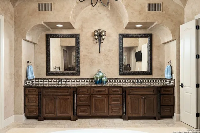 a bathroom with a tub sink and mirror