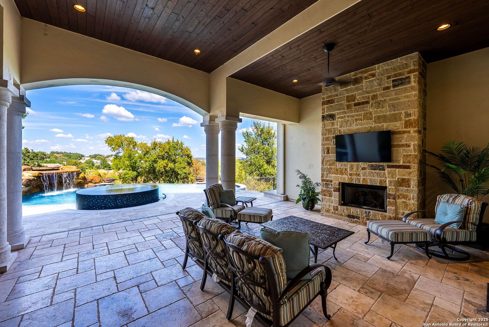 631 Menger Springs Boerne, TX 78006 - Photo 35 of 54 a living room with furniture a fireplace and a floor to ceiling window