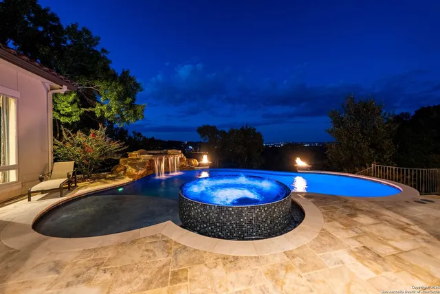 a swimming pool with outdoor seating and yard